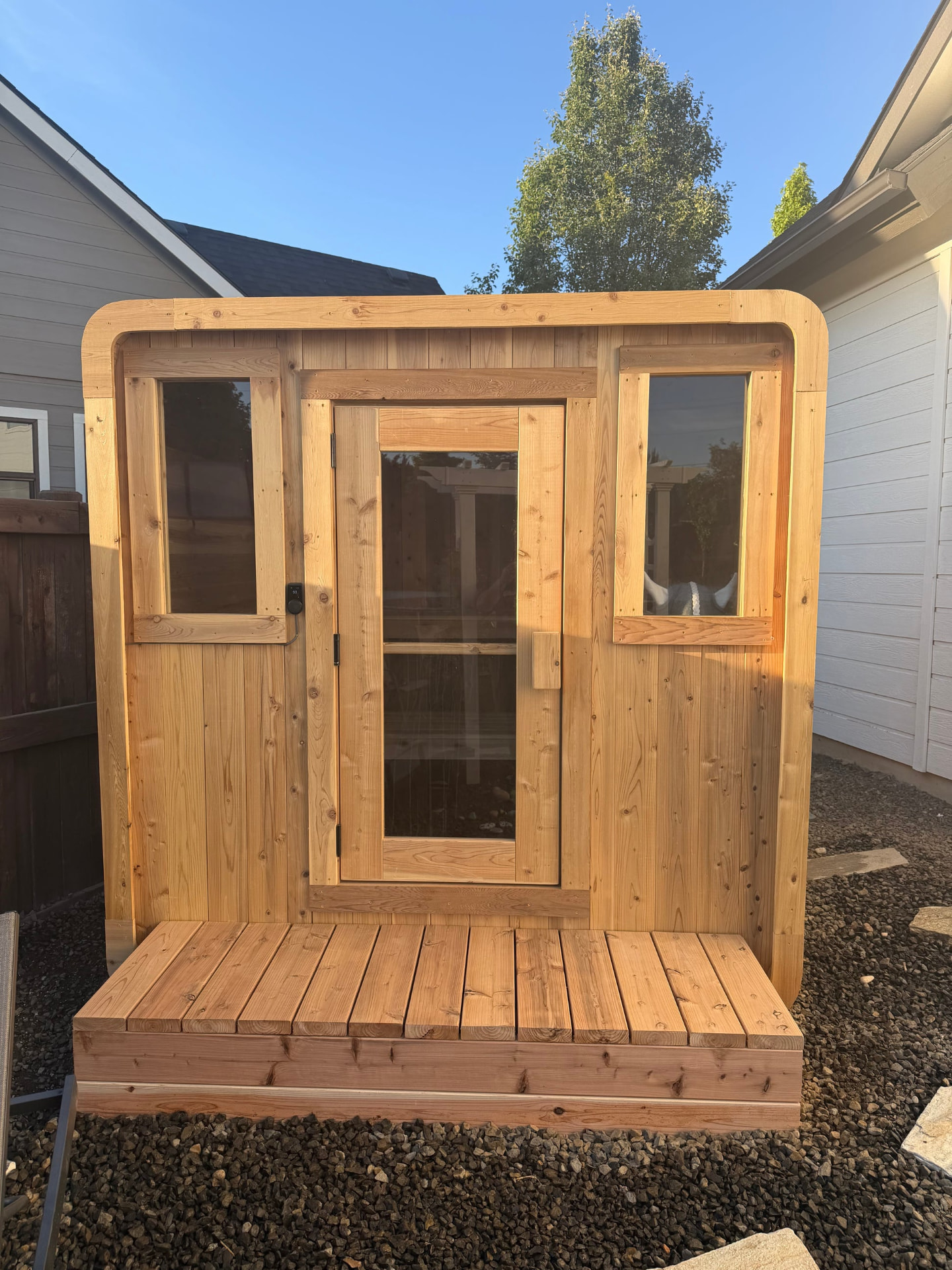 The Elbert 6-8 person cedar sauna, front elevation with cedar deck landing